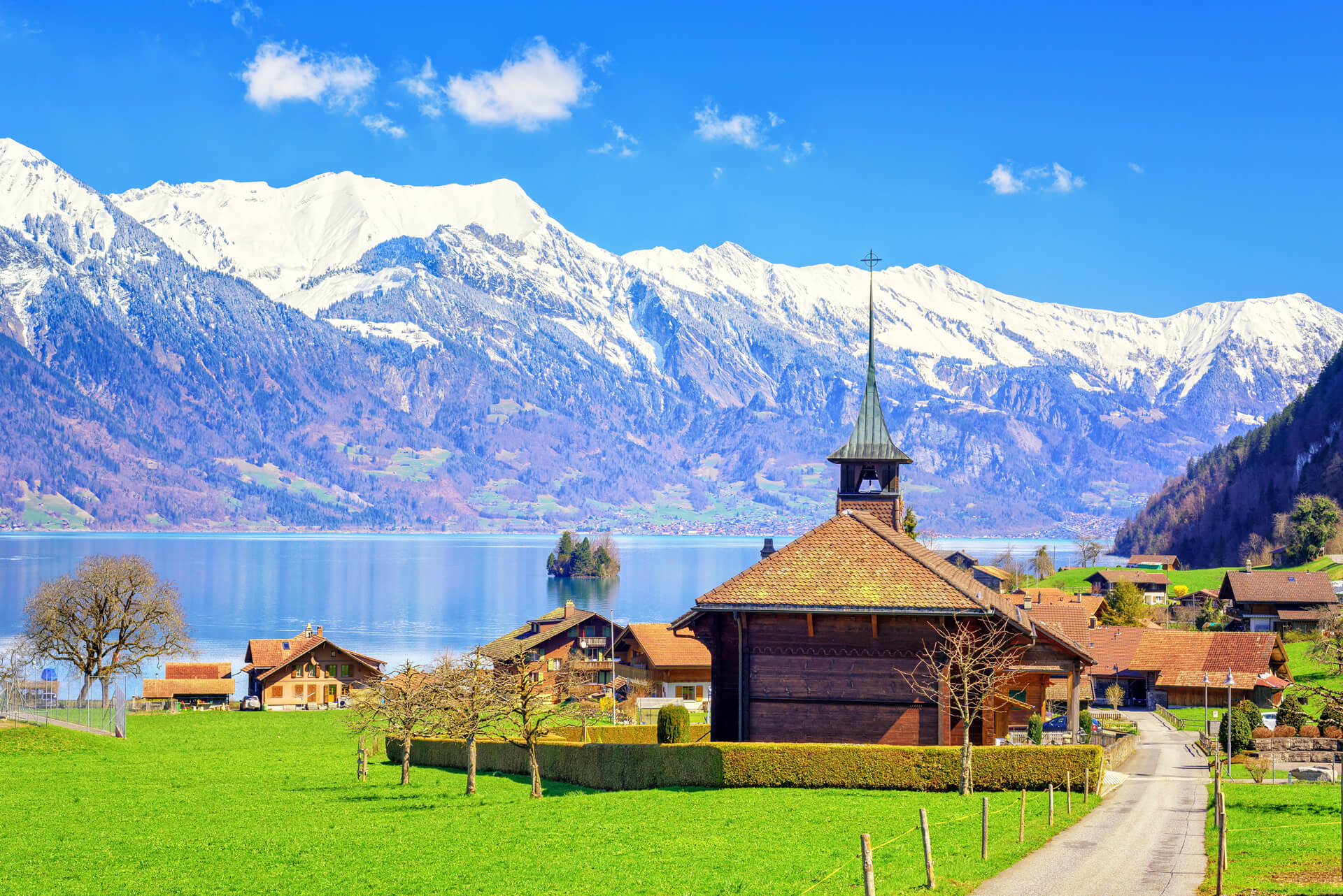 Wooden Church with alpine lake landscape in background Bern